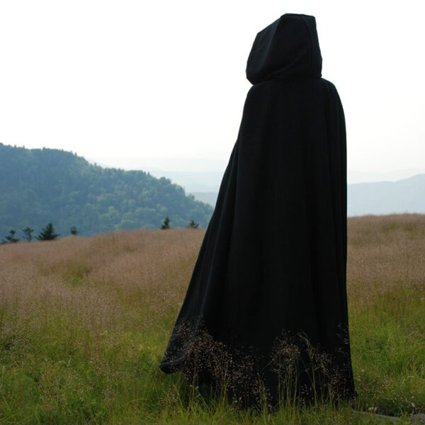 Cloaks for sale. Action image of a black wool cloak with full hood