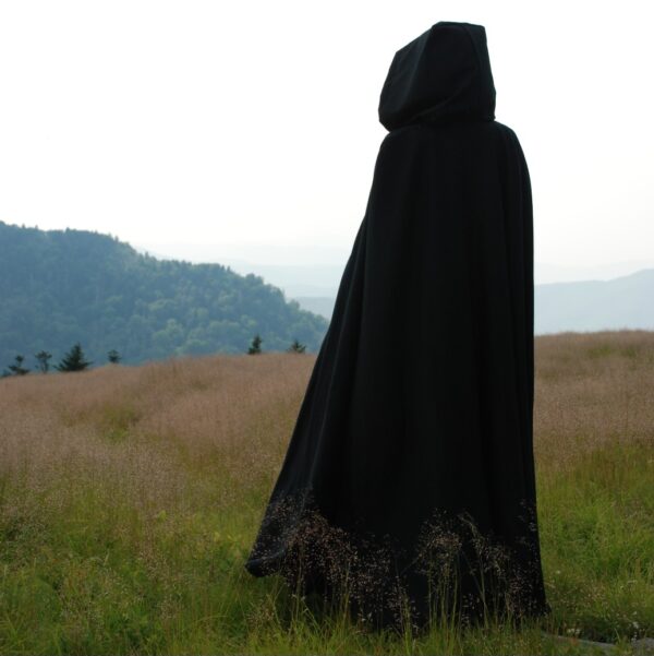 Cloaks for sale. A black wool cloak with full hood shown in action.